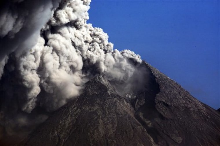 In this photo taken on Nov. 12, 2010, Mount Merapi spews volcanic material as seen from Argomulyo, Indonesia. Indonesia's stunning landscape is dotted by more than a hundred volcanos, a reminder of the fury that has been building beneath the earth's crust for millions of years. 
